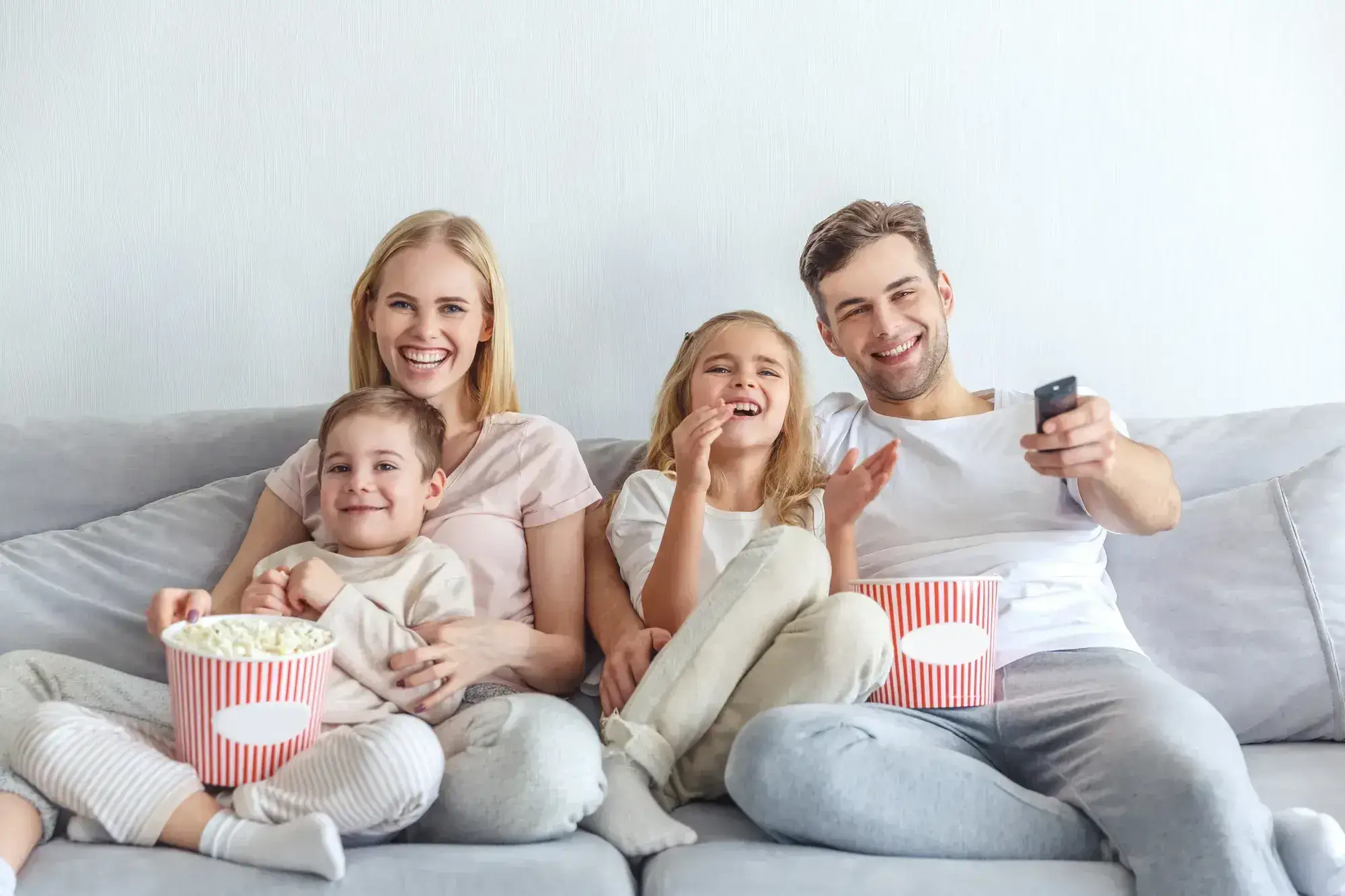 Family enjoying home entertainment on television